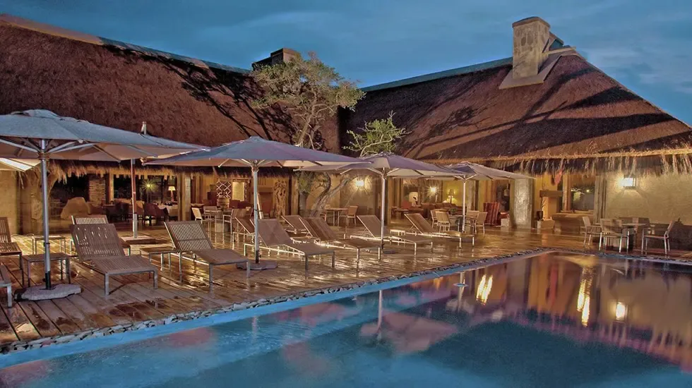 Evening falls over the pool deck at a Kapama lodge in South Africa.
