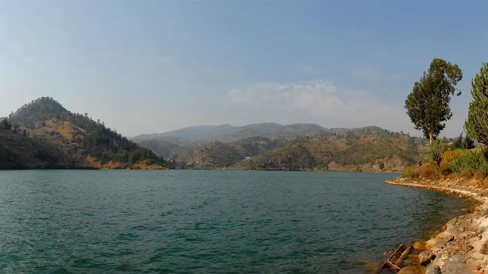 Calm waters and green hills along the shore at Kibuye, Rwanda.