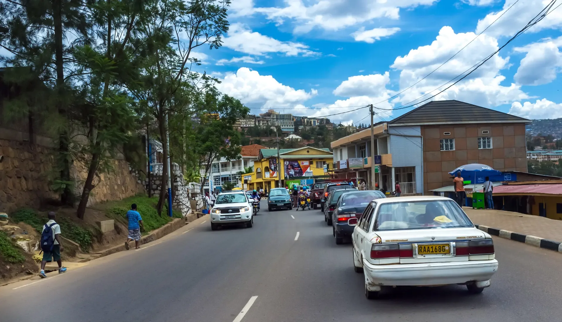 Traffic and pedestrians on a busy street in Kigali, Rwanda.