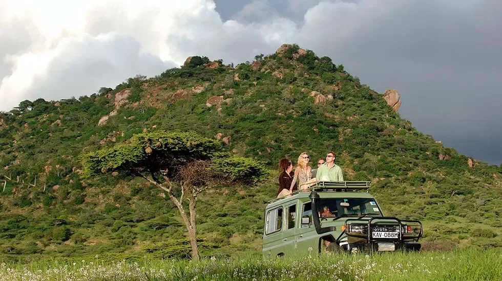Guests take in the view from a safari vehicle in Laikipia, Kenya.
