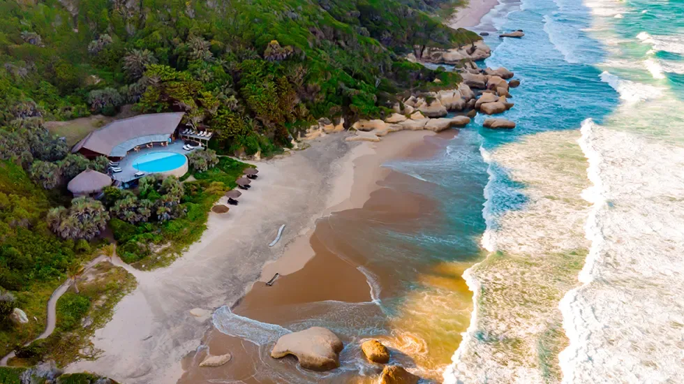 Beachfront lodge and pool above the sand at Massinga Beach, Mozambique.