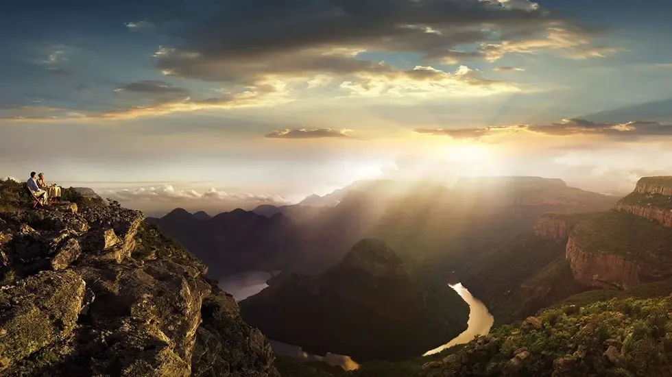 Sunbeams over the Panorama Route, seen from a rocky viewpoint in South Africa.