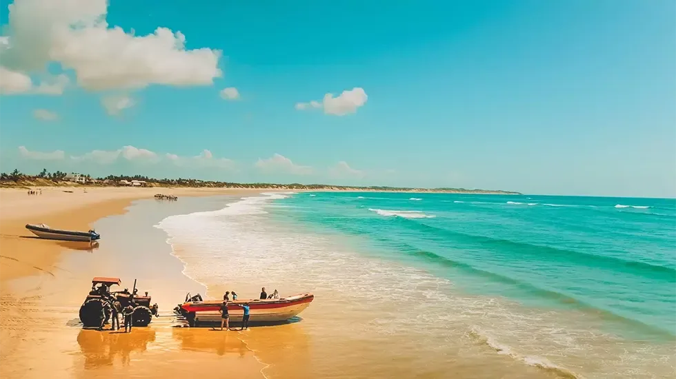 Fishing boats and a tractor on the sand at Praia Do Tofo, Mozambique.