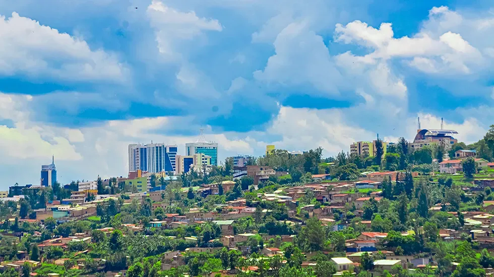 Kigali's skyline rising over green hills before departure from Rwanda.