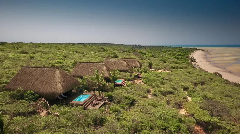 Thatched beachside chalets above the sand at Vilanculos, Mozambique