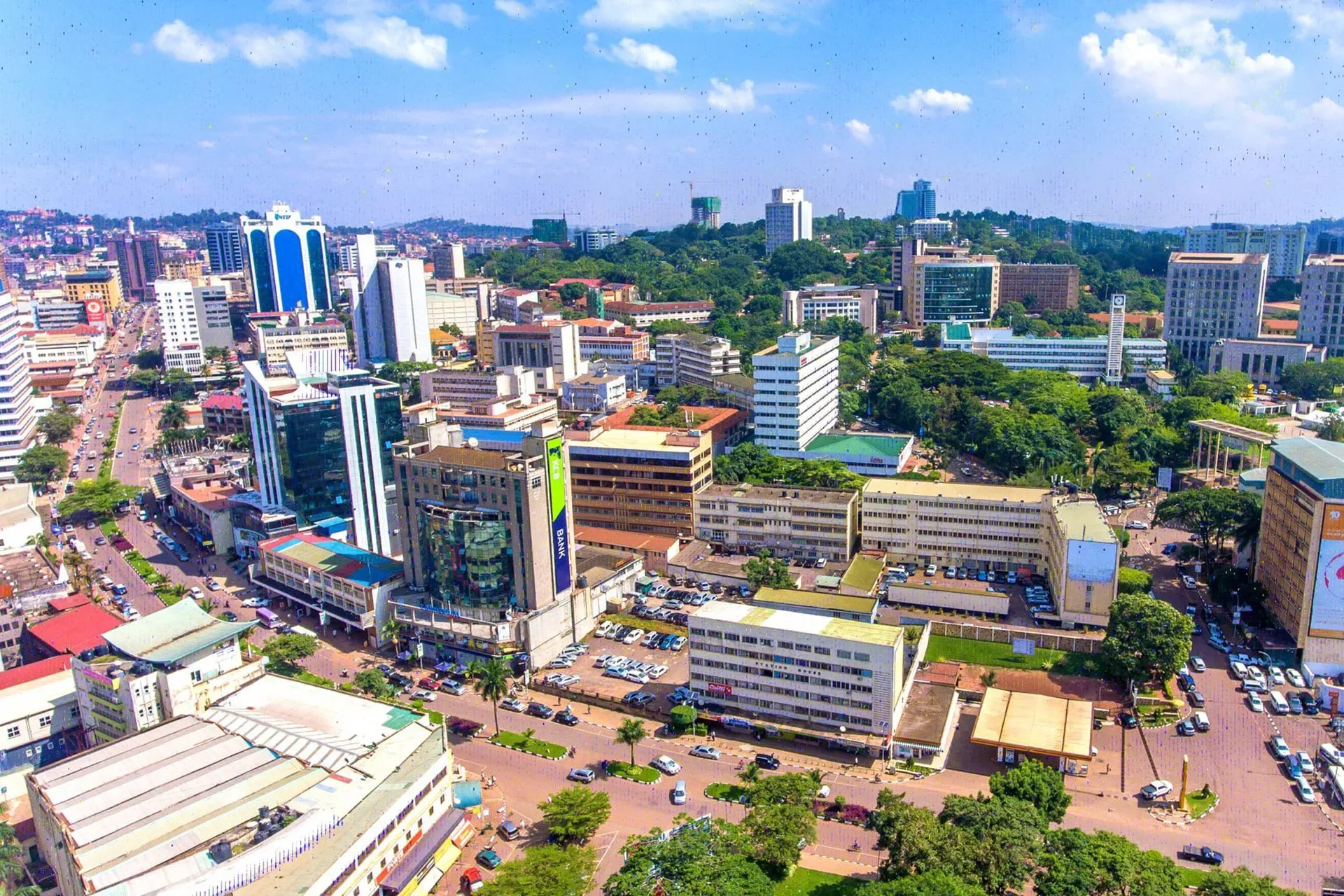 Kampala's skyline rising above tree-lined streets and busy roads in the Ugandan capital.