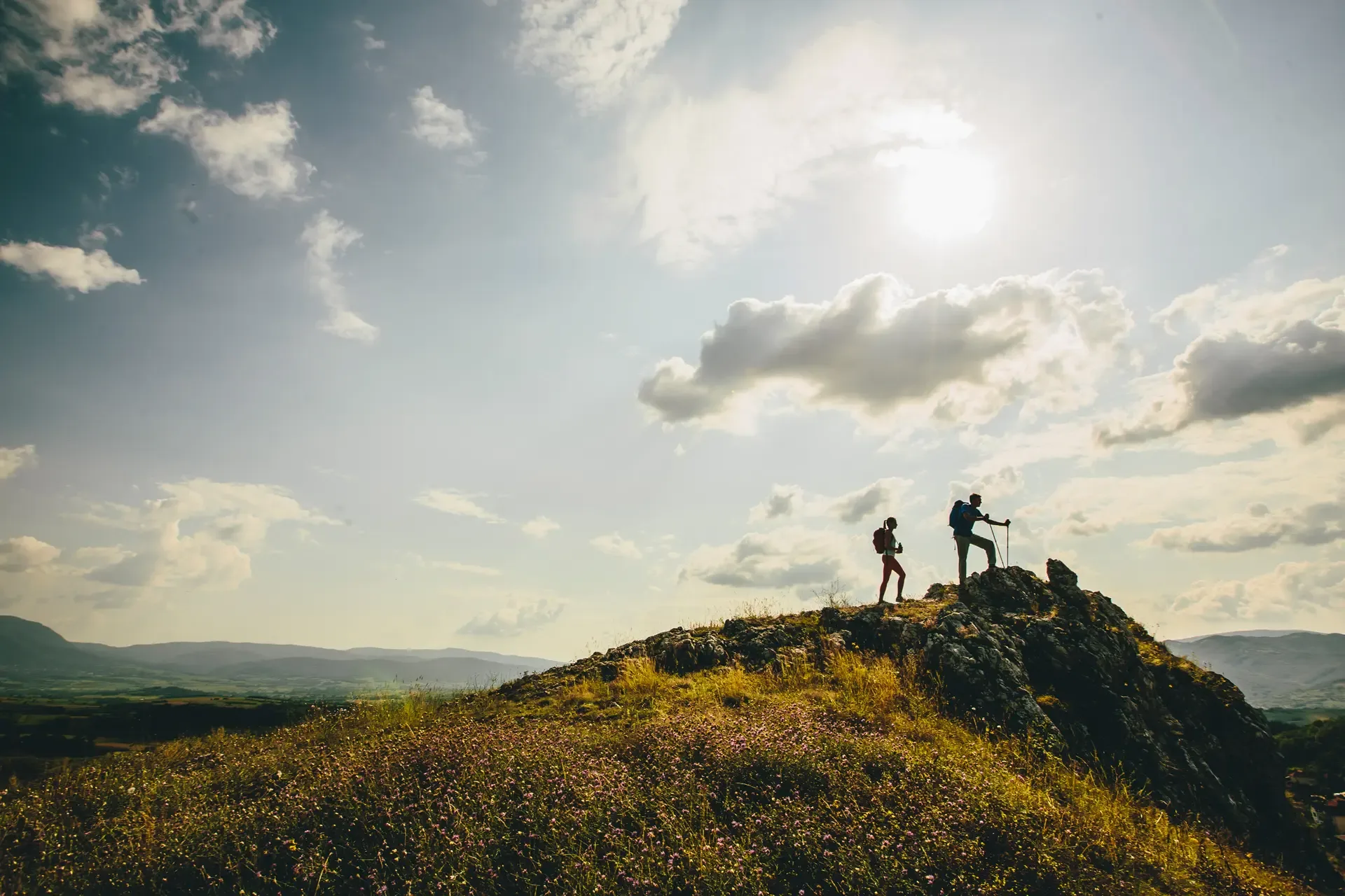 Hikers with backpacks walking top mountain enjoy hiking