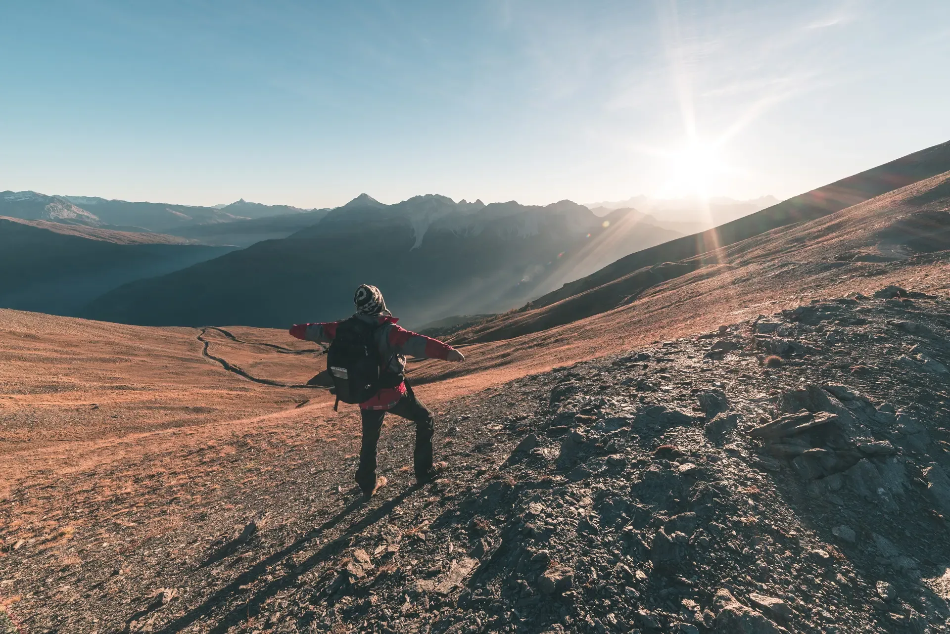 Male hiker relaxing sunset mountain summit looking majestic panorama italian alps