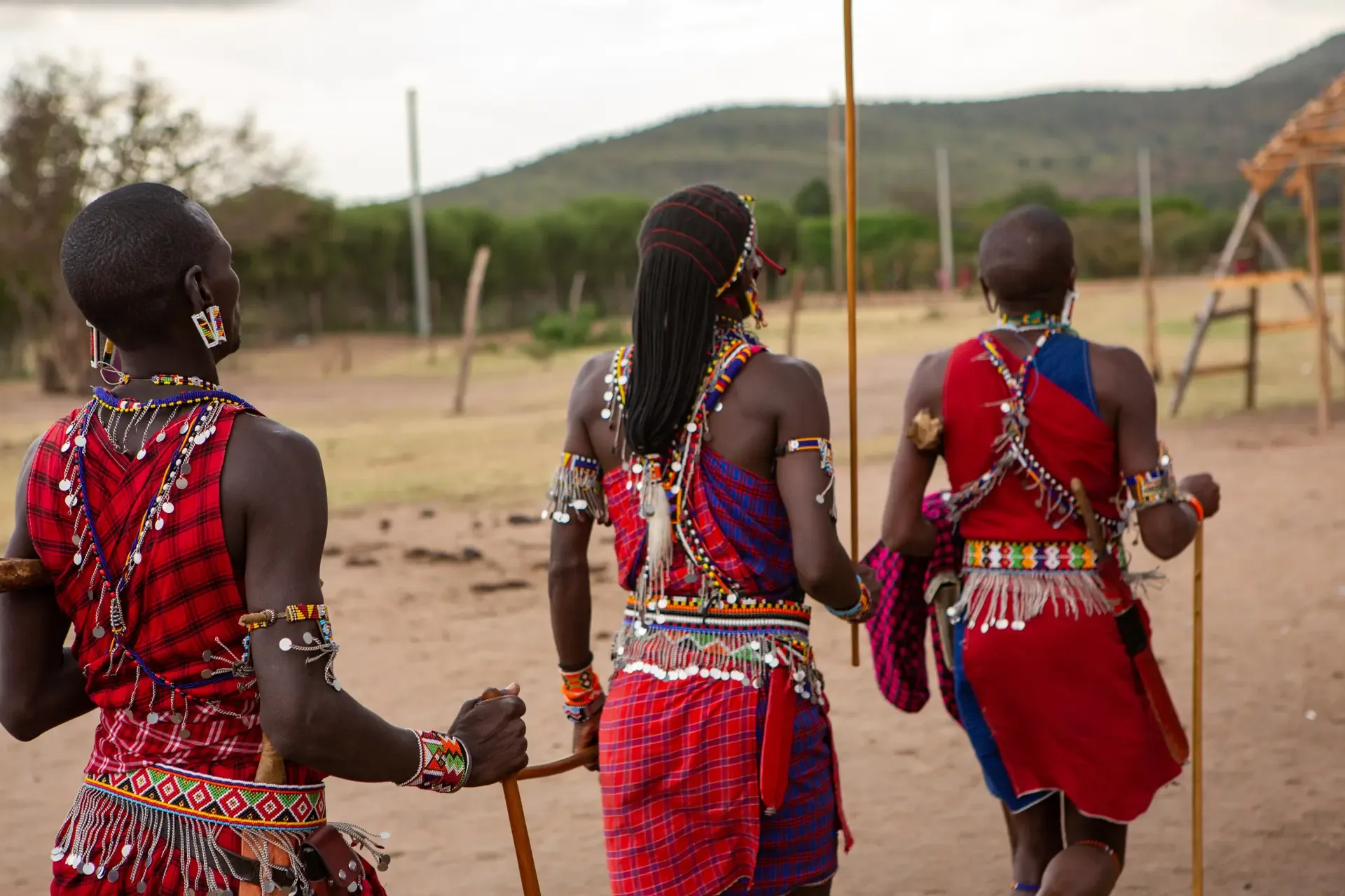 Maasai dancers in traditional dress performing the jumping dance at a village