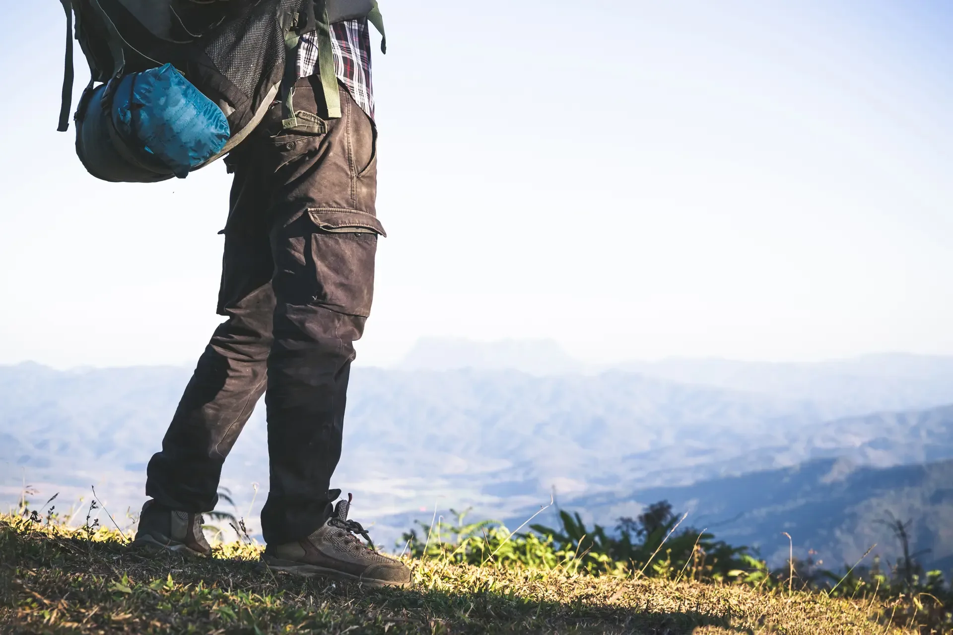 Tourist from mountain top sun rays man wear big backpack against sun light