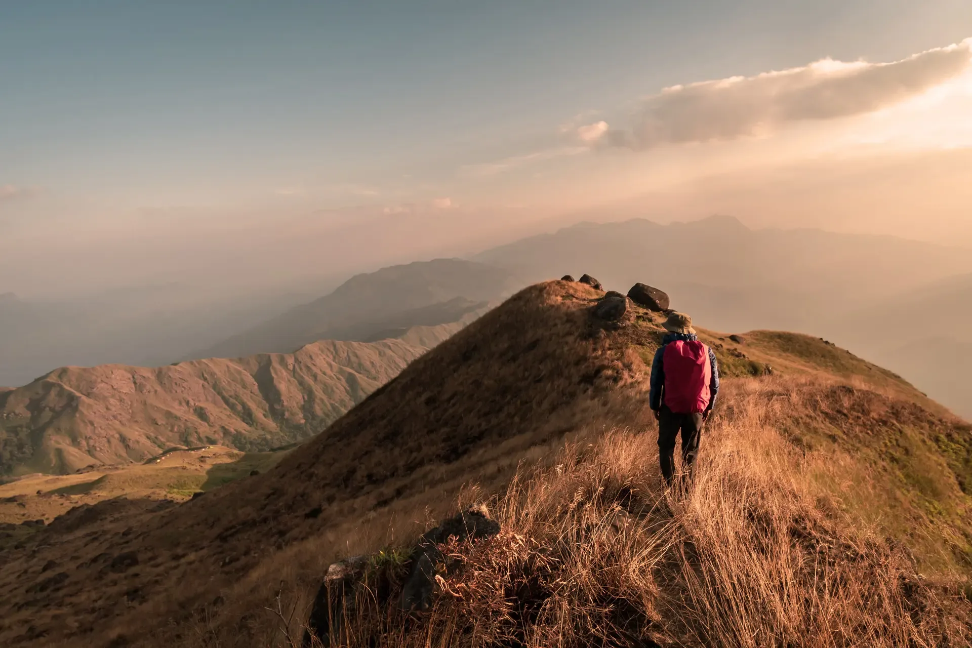 Young man traveler with backpack trekking mountain