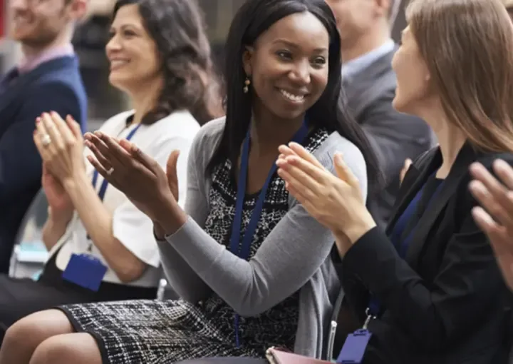 Delegates applauding during a leadership development session